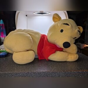 Disney Winnie the Pooh lounging plush toy.